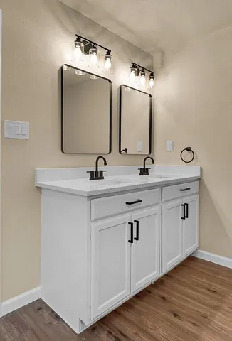 a bathroom with a double vanity sink and mirror