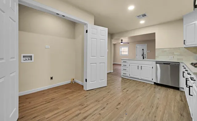 a view of a kitchen with wooden floor and a sink