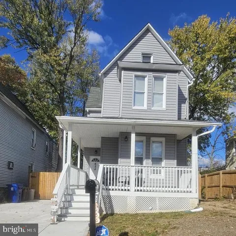 a front view of a house with a yard and porch