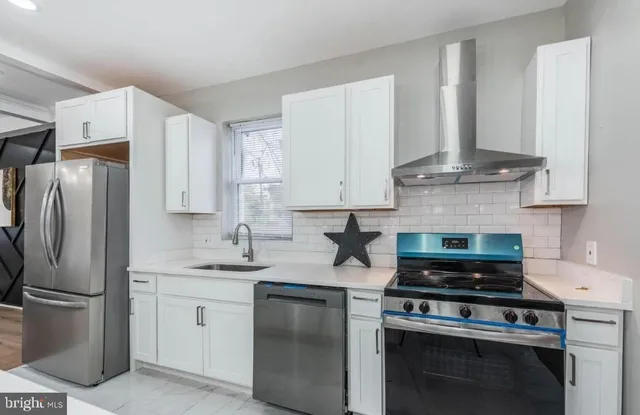 a kitchen with stainless steel appliances granite countertop a stove a refrigerator and a stove