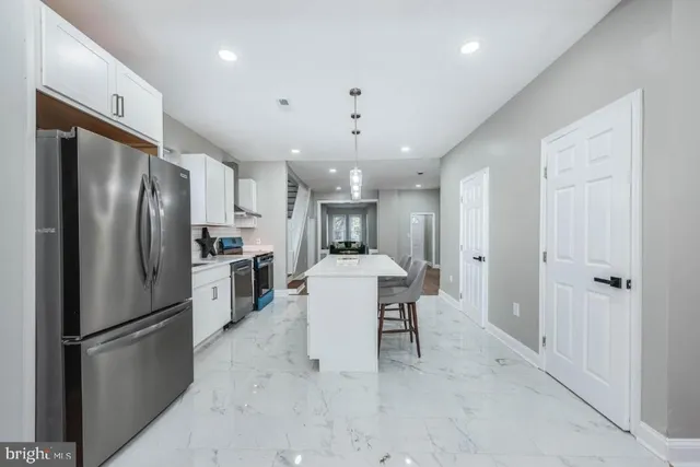 a kitchen with refrigerator a sink dishwasher a stove and a refrigerator with wooden floor