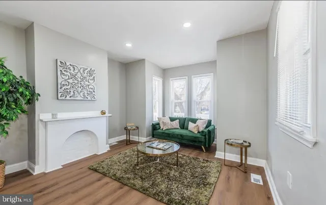 a living room with furniture a rug and a fireplace