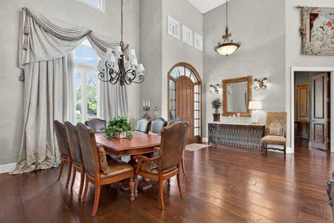 a living room with furniture large window and a fireplace
