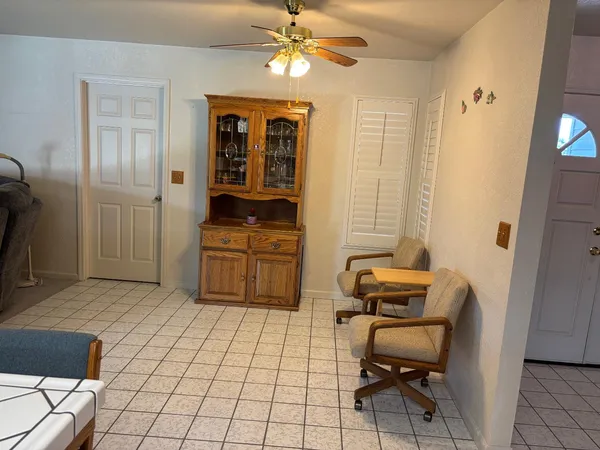 a view of a workspace with furniture and a window