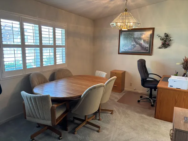 a view of a dining room with furniture a livingroom and wooden floor