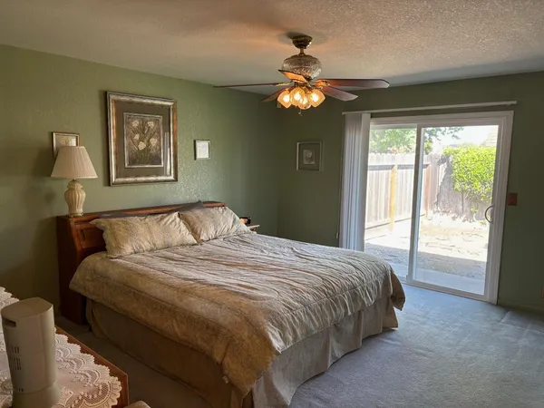 a bedroom with a large bed and a window