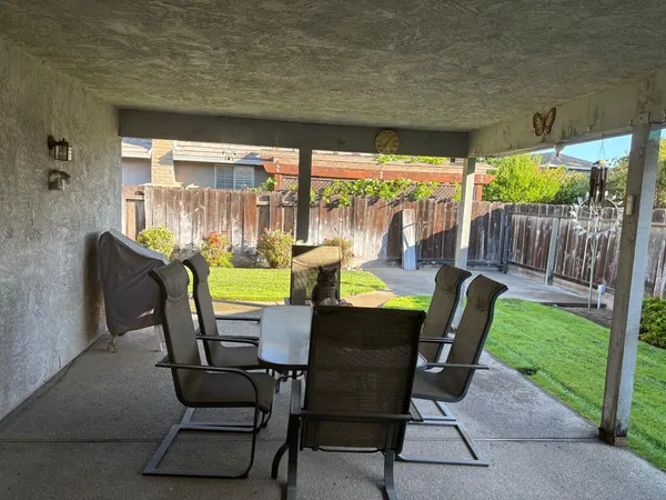 a view of a porch with furniture and garden