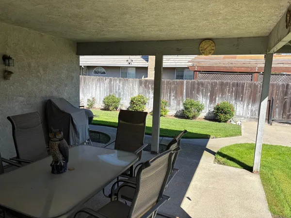 a view of a patio with chairs and a table