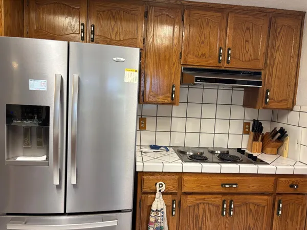 a kitchen with a refrigerator and cabinets