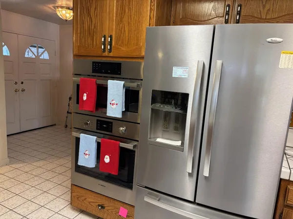 a kitchen with stainless steel appliances granite countertop a refrigerator and a stove
