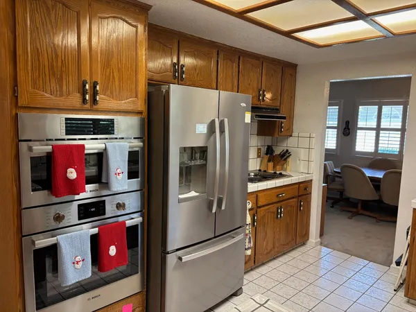 a kitchen with stainless steel appliances granite countertop a refrigerator and a stove
