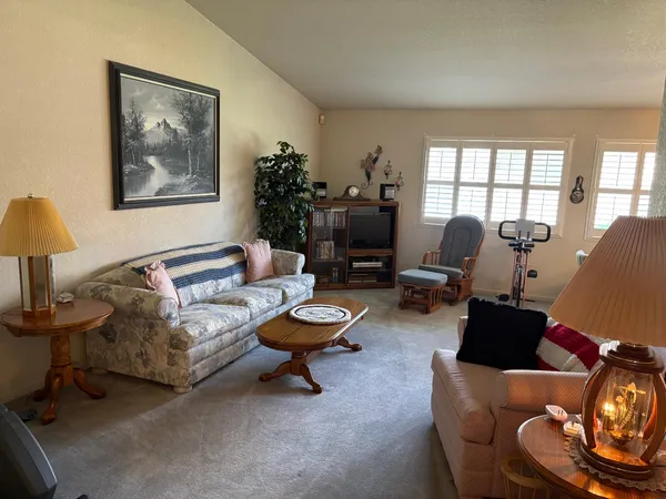 a living room with furniture and a lamp