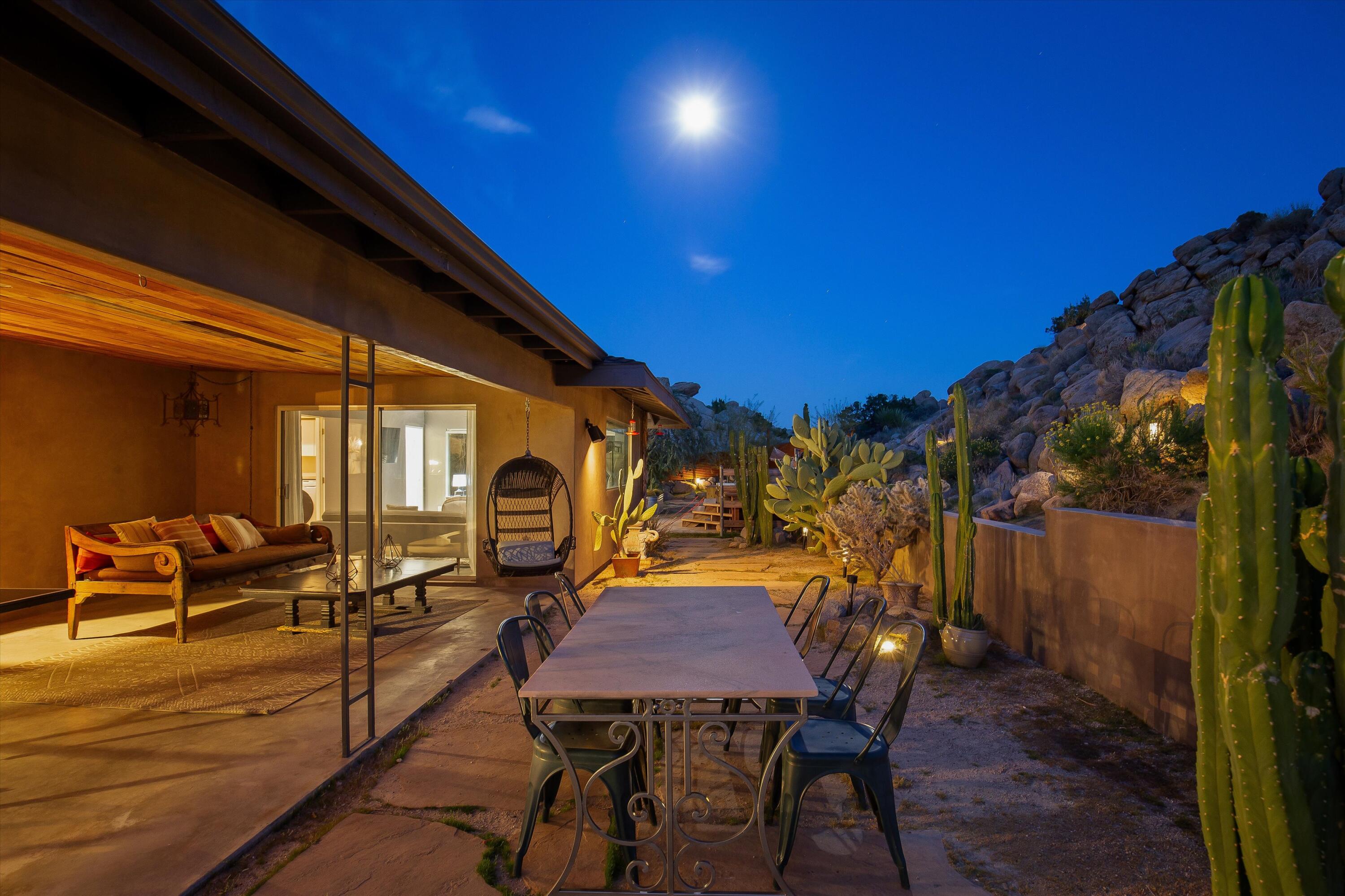 57113 Farrelo Road Yucca Valley, CA 92284 - Photo 13 of 50 a view of a patio with table and chairs with wooden floor and fence