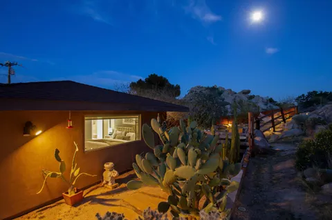a backyard of a house with table and chairs