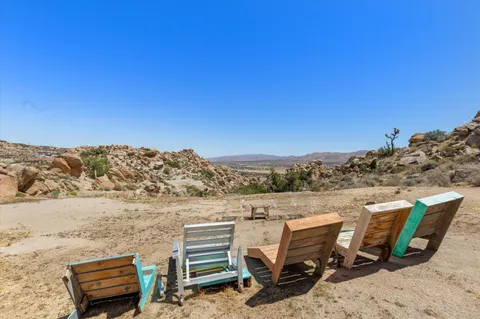 a bedroom with a bed a couch and dresser