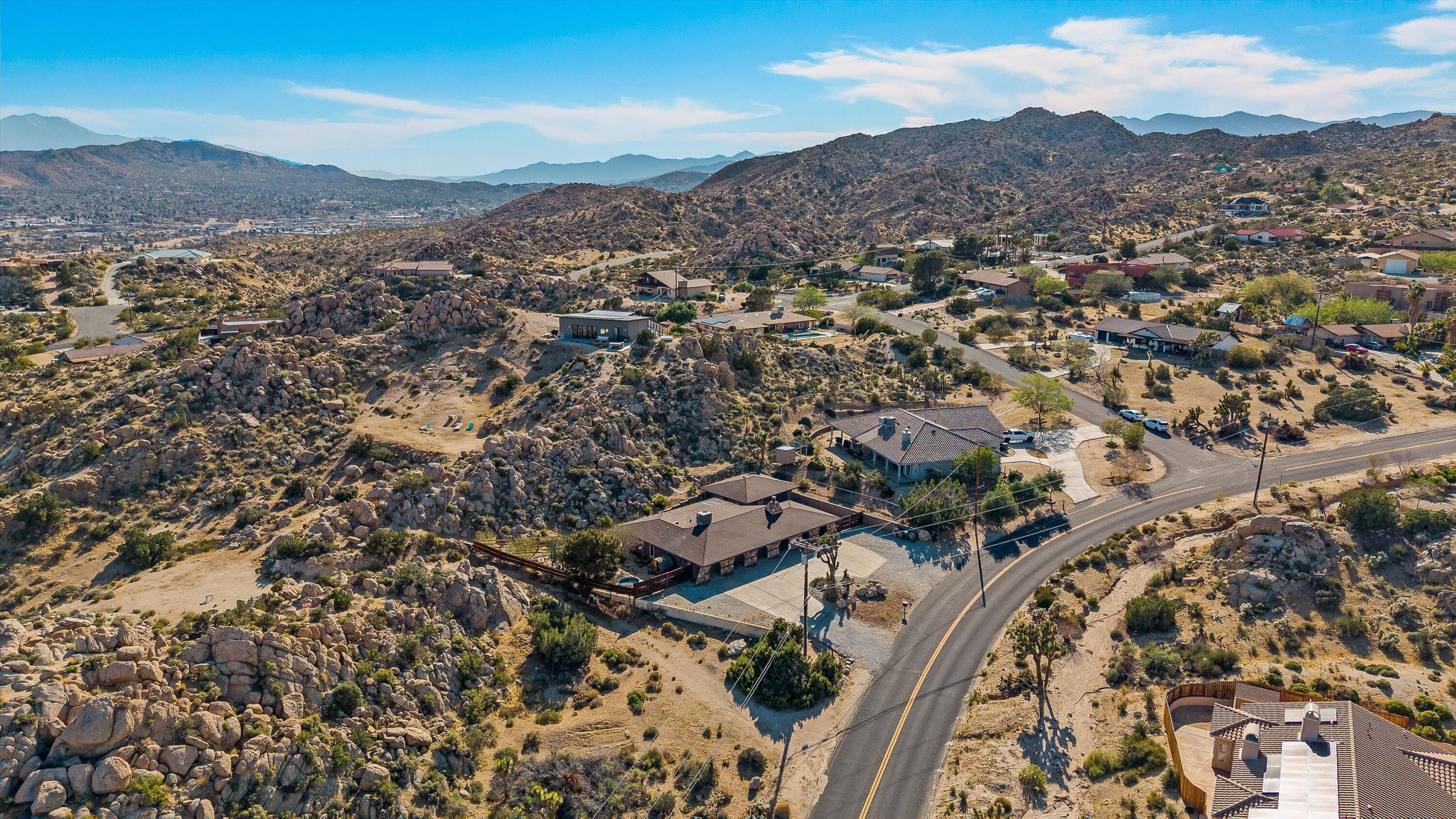 57113 Farrelo Road Yucca Valley, CA 92284 - Photo 2 of 50 an aerial view of residential house and sandy dunes