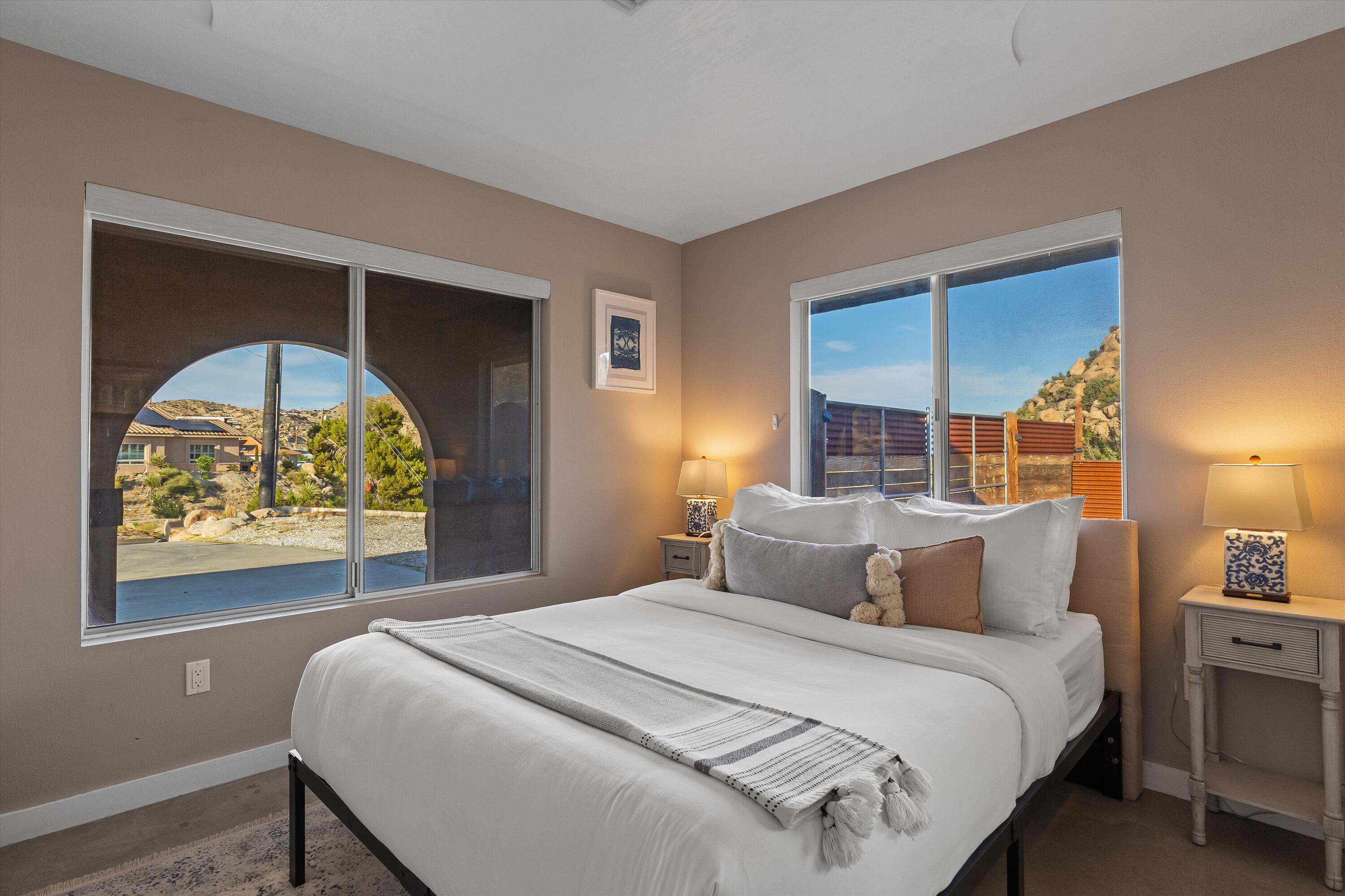 57113 Farrelo Road Yucca Valley, CA 92284 - Photo 26 of 50 a bedroom with a bed and a painting on the wall