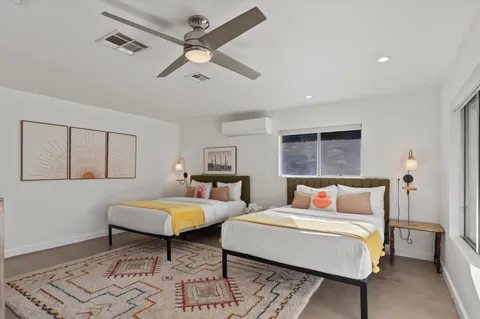 a bedroom with furniture and a flat screen tv