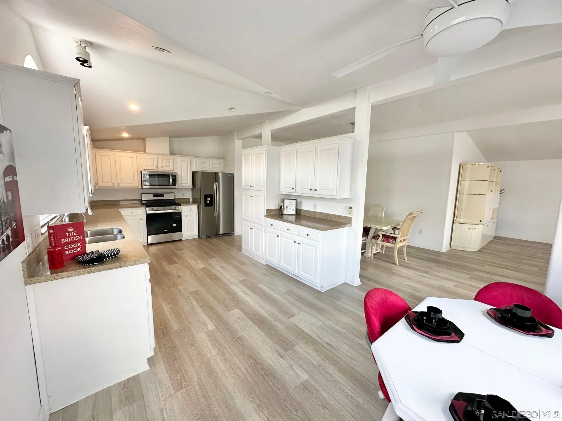13307 Alpine Drive, Unit 2 Poway, CA 92064 - Photo 3 of 13 a kitchen with stainless steel appliances kitchen island granite countertop a stove and a sink