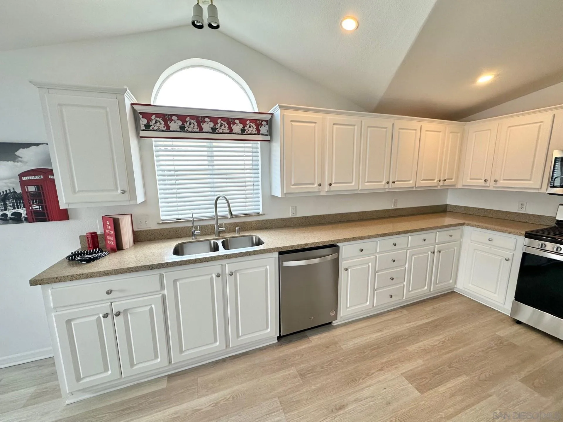 13307 Alpine Drive, Unit 2 Poway, CA 92064 - Photo 7 of 13 a view of a kitchen sink with white cabinets