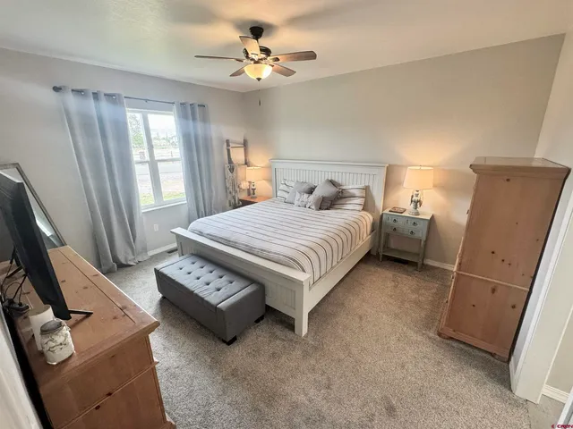 a bedroom with a bed dresser and a window