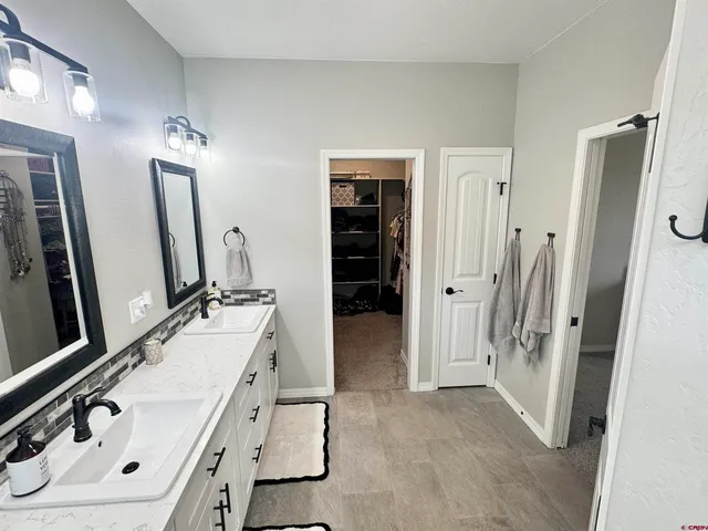 a bathroom with a sink double vanity and a mirror