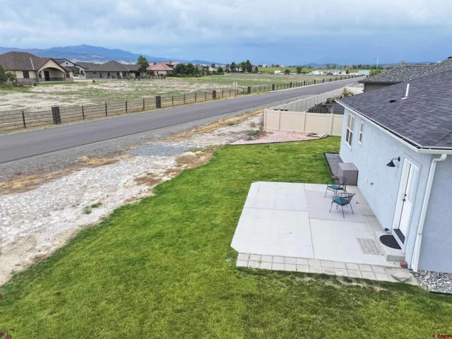 an aerial view of a house with a yard and lake view