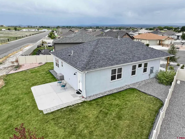 an aerial view of a house with a yard and lake view