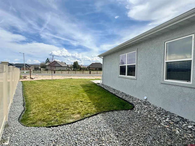 a aerial view of a house with a yard and lake view