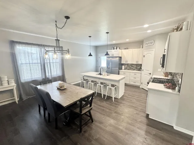 a large kitchen with a table and chairs