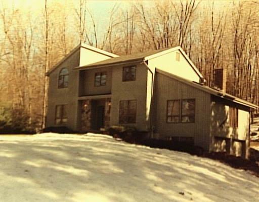 a view of a house with snow on the road