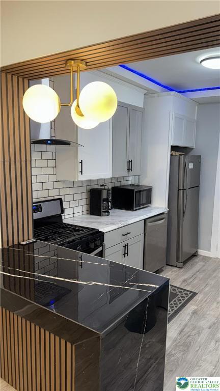 1104 South 7th Street Allentown, PA 18103 - Photo 11 of 27 a kitchen with stainless steel appliances granite countertop a sink and a stove