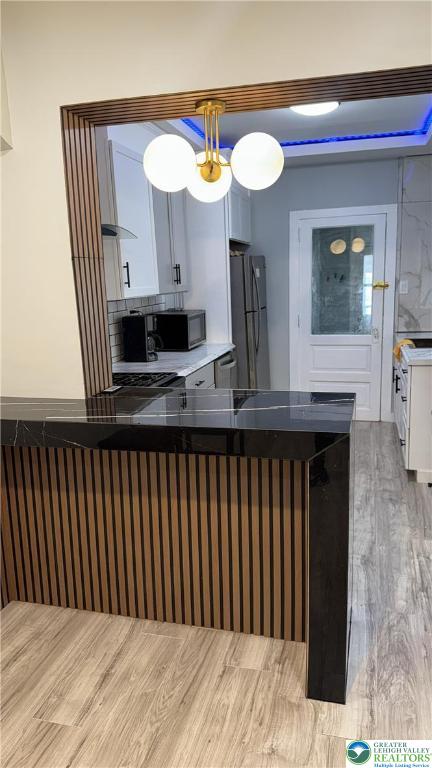 1104 South 7th Street Allentown, PA 18103 - Photo 12 of 27 a kitchen with a sink a mirror and wooden floor