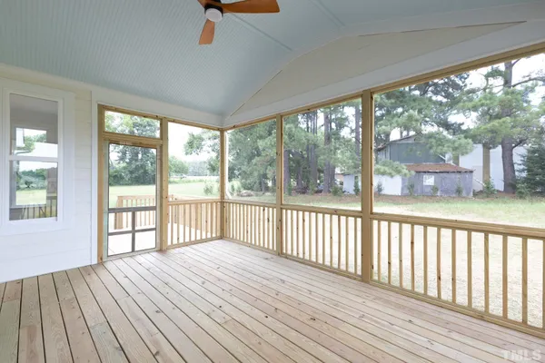 a view of a porch with wooden floor and outdoor space