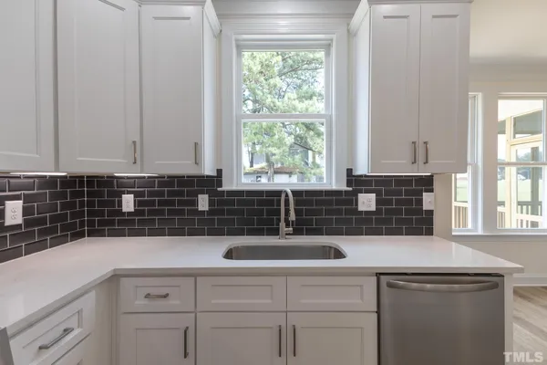 a kitchen with a sink and cabinets