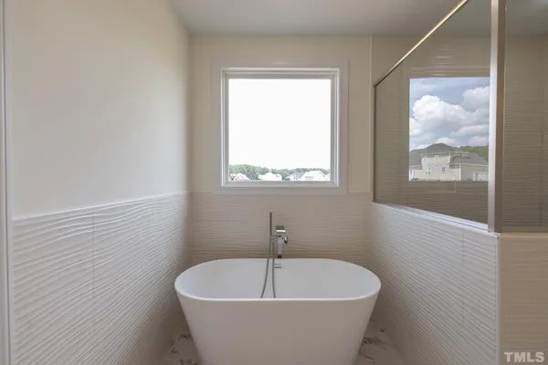 a white bath tub sitting in a bathroom
