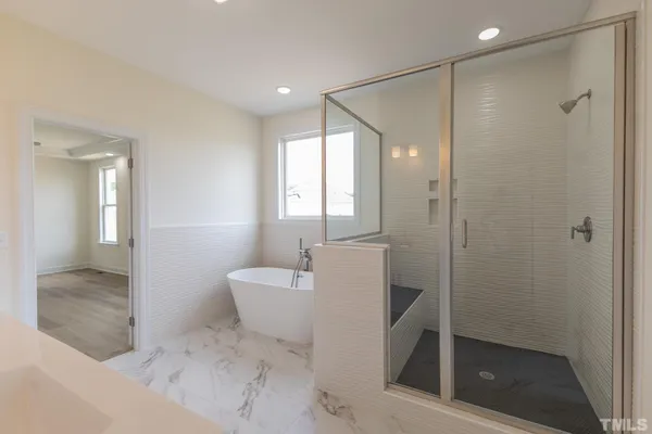 a spacious bathroom with a bathtub and a shower