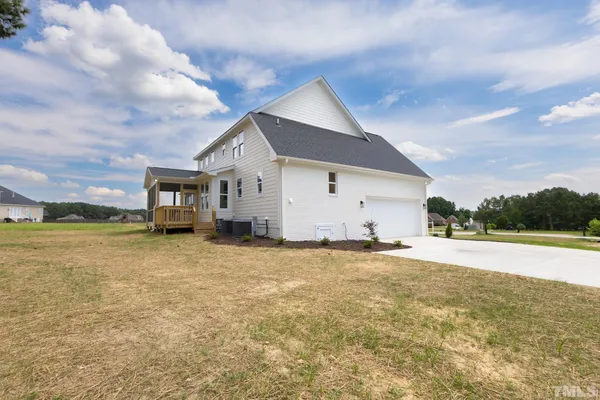 a view of a house with a yard and garage
