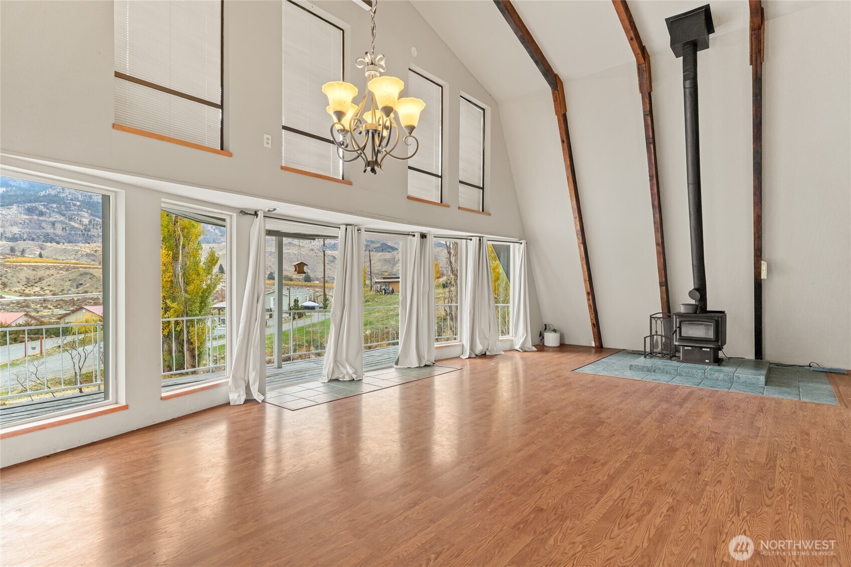 110 Bill Shaw Road Pateros, WA 98846 - Photo 11 of 39 a view of an empty room with wooden floor and fan
