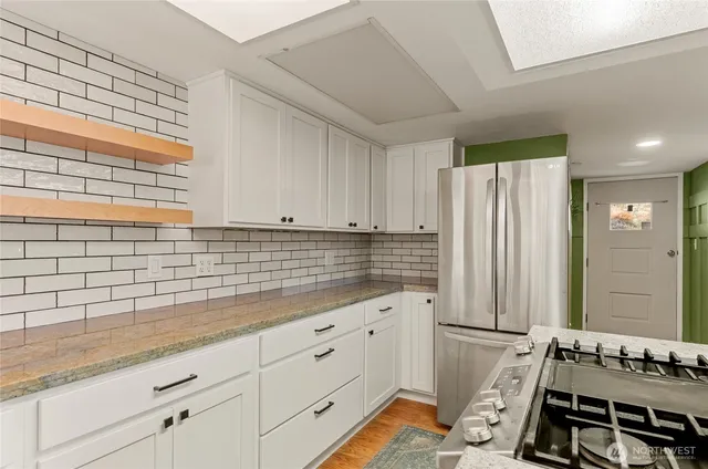 a kitchen with a stove a sink and a refrigerator