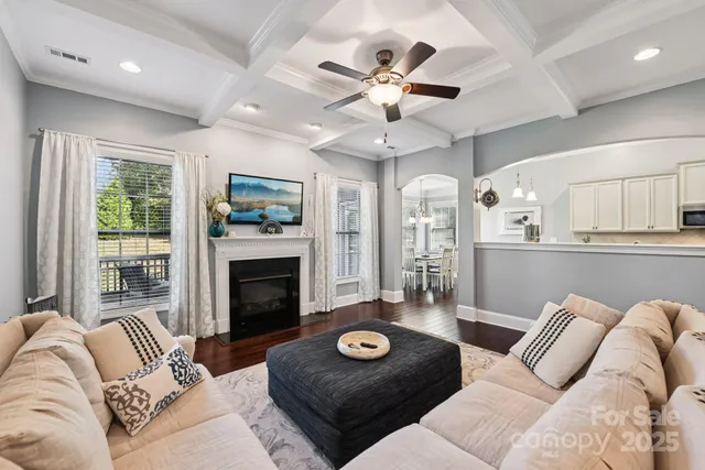 a living room with furniture a fireplace and a large window