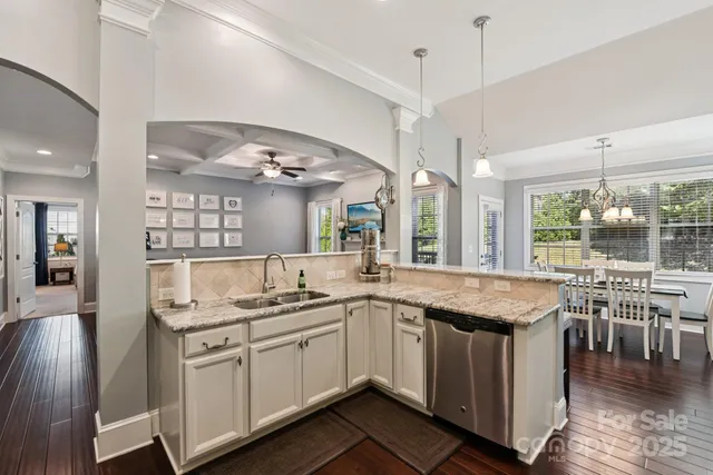 a open kitchen with a sink and cabinets