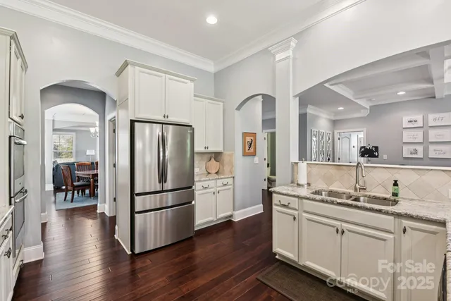 a kitchen with stainless steel appliances granite countertop a refrigerator and a stove top oven