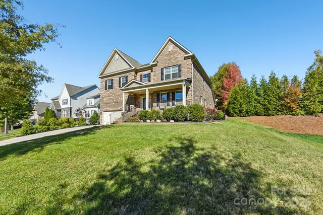 a front view of a house with yard and green space