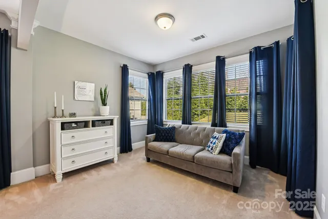 a living room with furniture and windows
