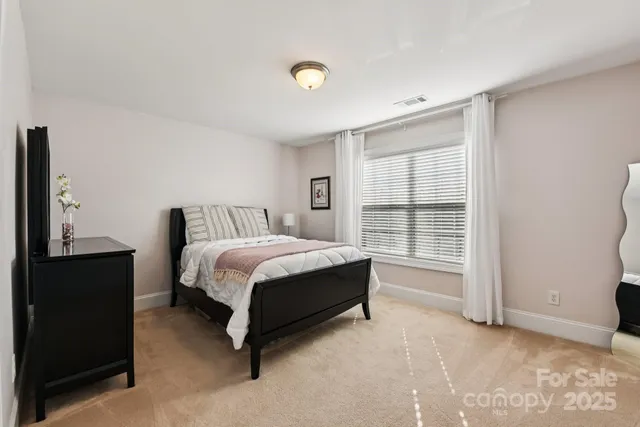 a spacious bedroom with a bed and a window