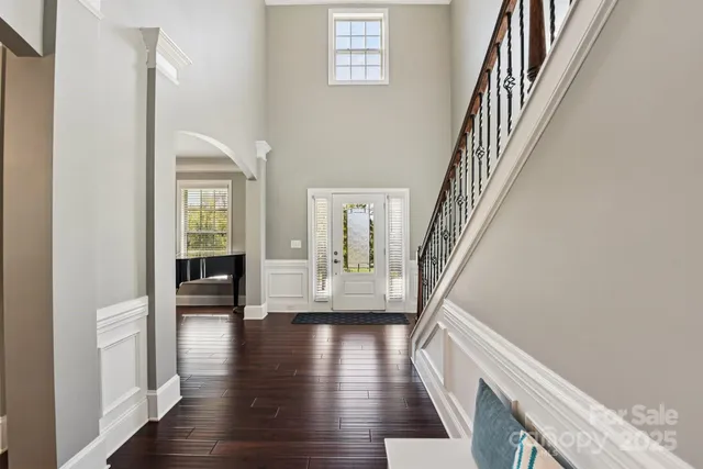 a view of an entryway with wooden floor and stairs