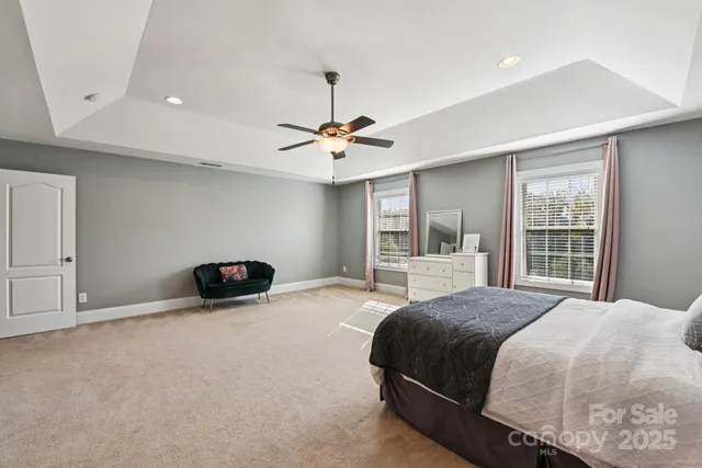 a spacious bedroom with a bed and a window