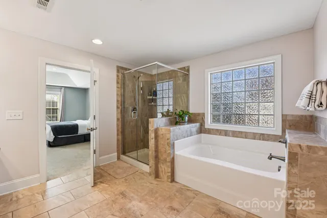 a spacious bathroom with a tub and shower