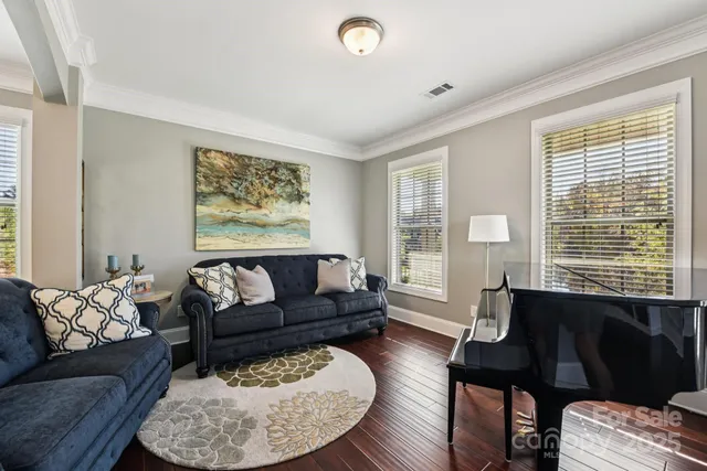 a living room with furniture couches and a large window